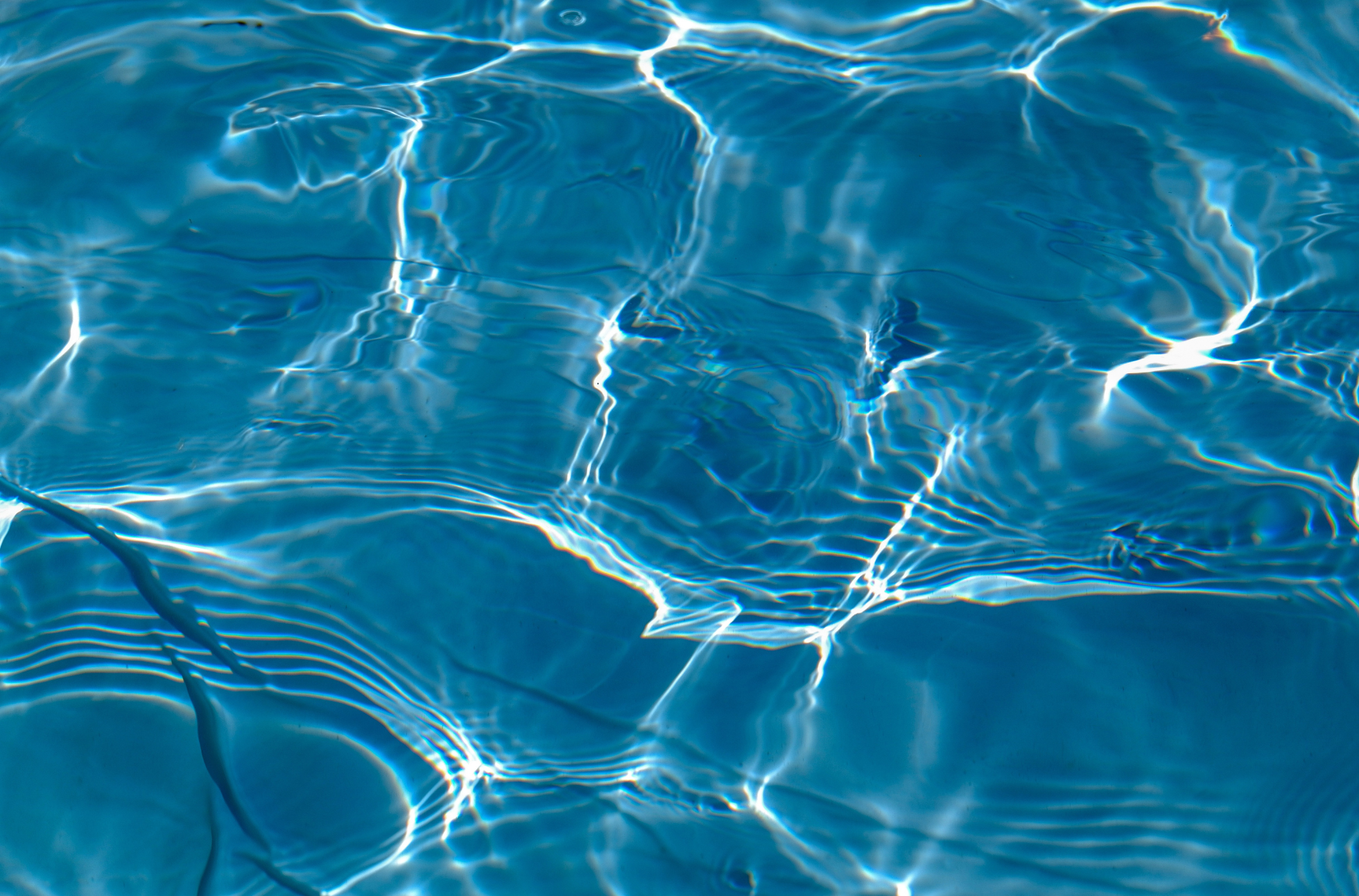 Close-up of clear blue water with light reflections