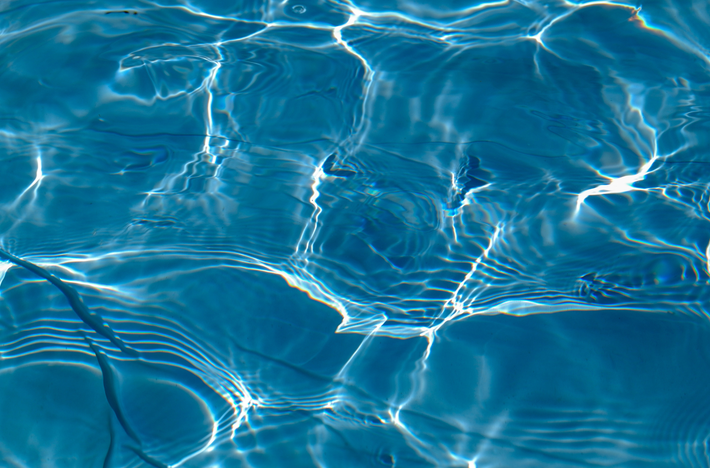 Close-up of clear blue water with light reflections