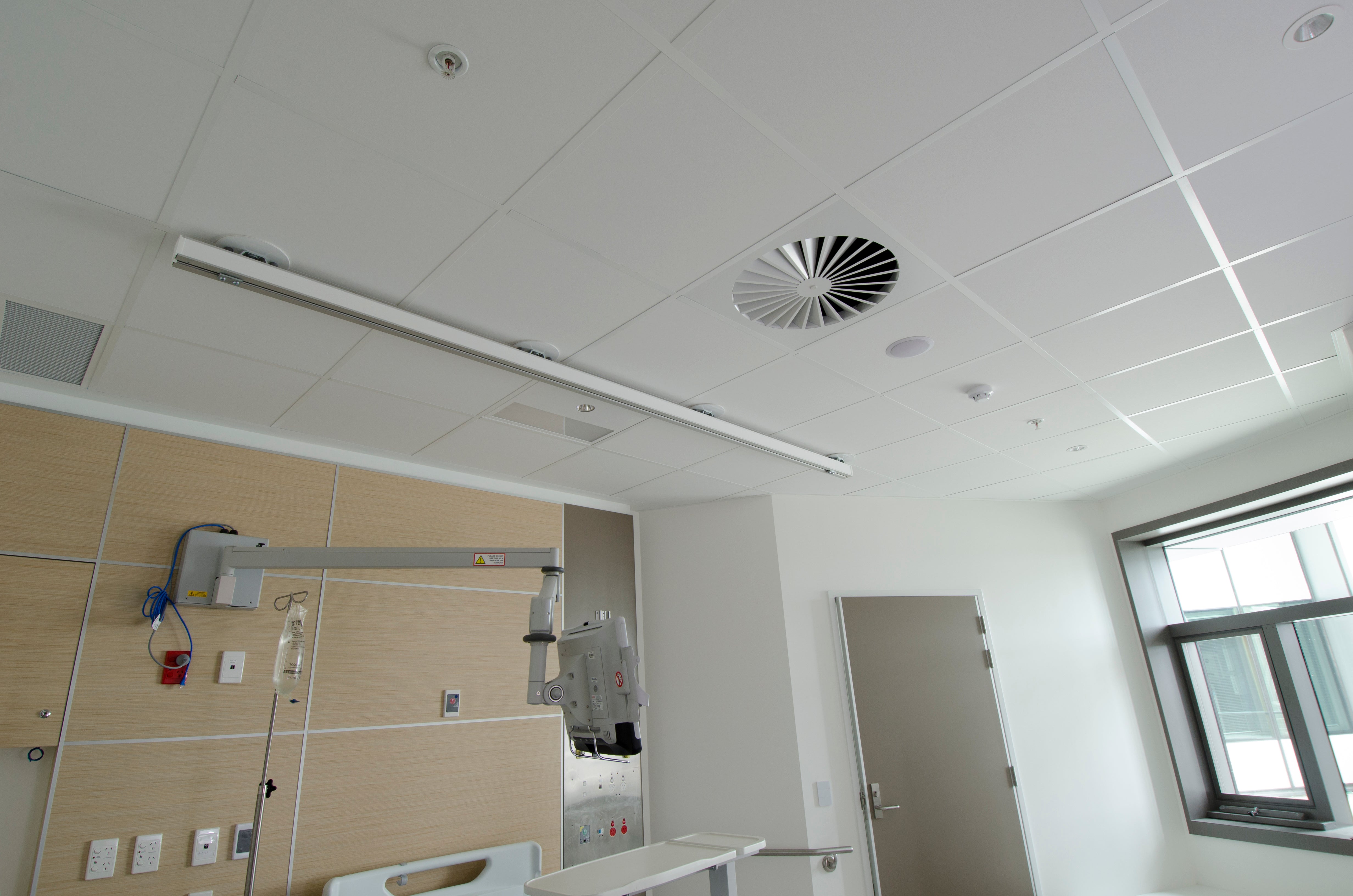 Seismic ceiling system installed in the Royal Adelaide Hospital with equipment and a window.