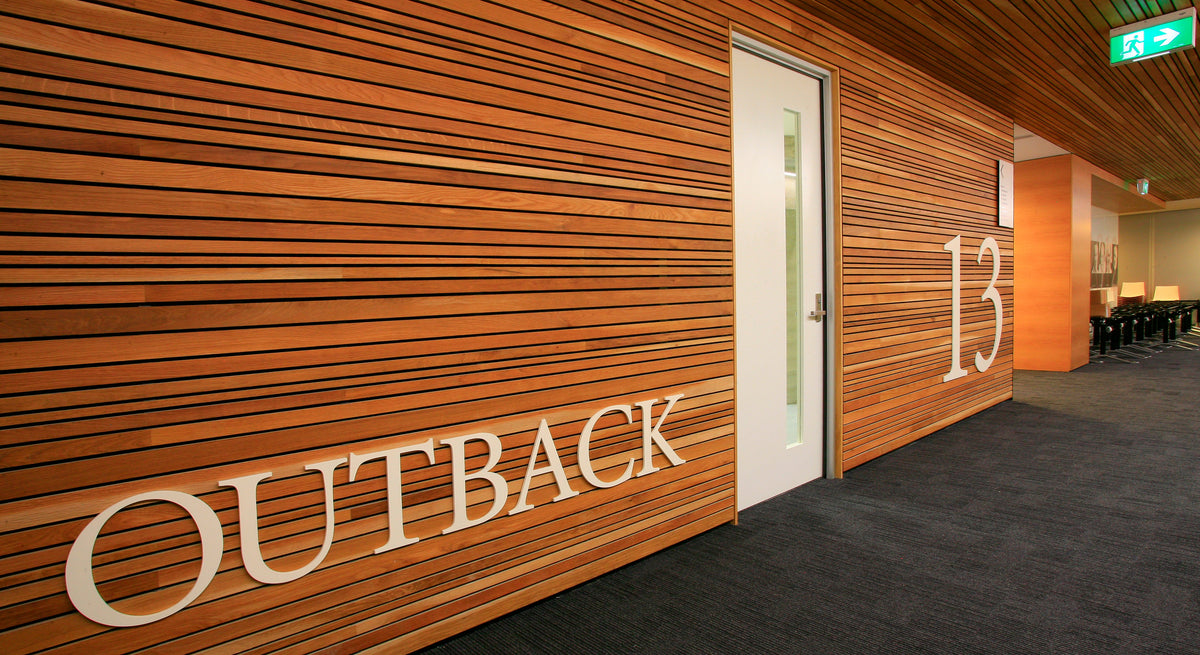 Studform door in an indoor space with number 13 and outback attached to the wooden walls. 