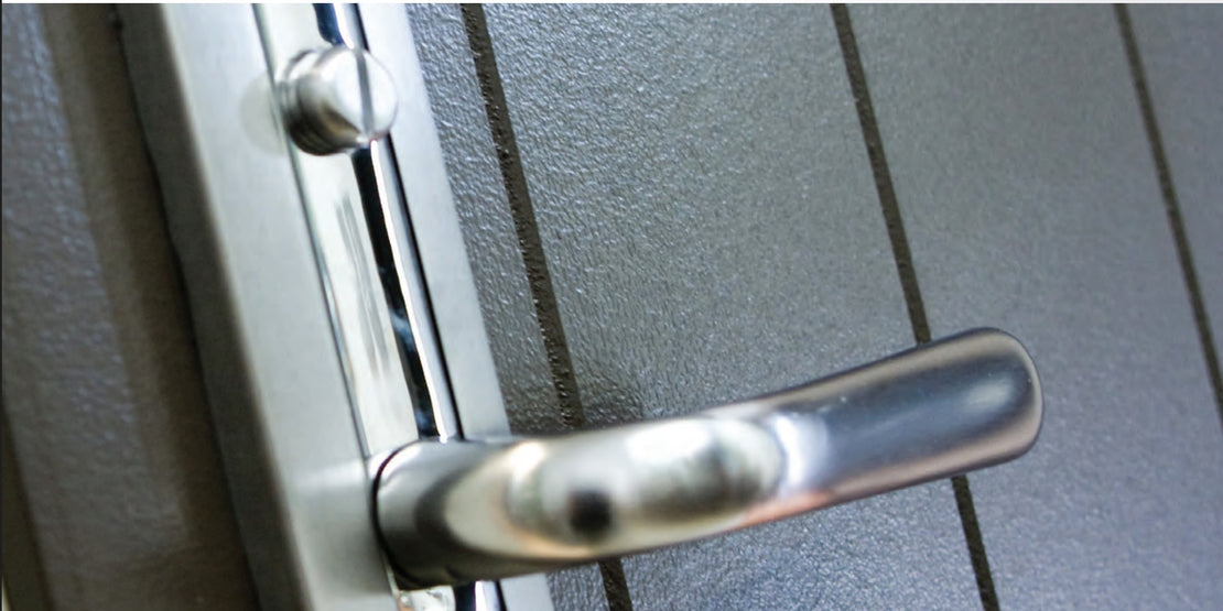 Metal door handle on a metallic surface